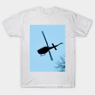 A Bell UH-1 Huey Iroquois flying low over trees T-Shirt